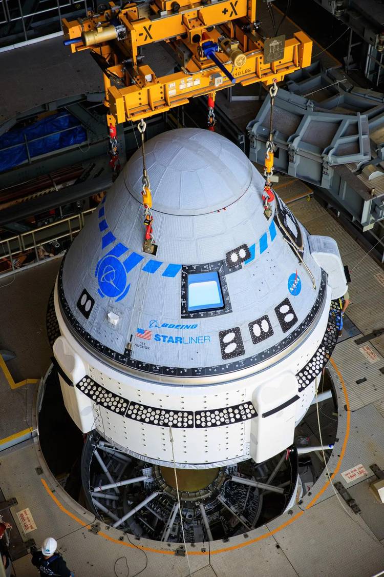 Boeing’s Starliner spacecraft is hoisted for service