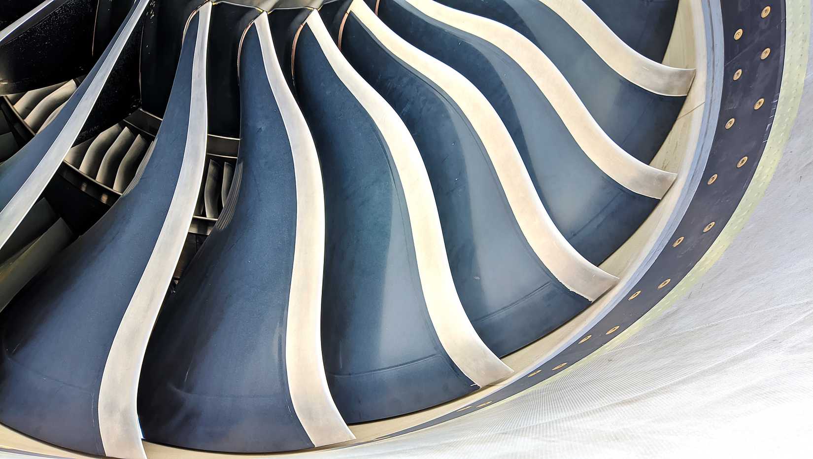 Close-up of airplane turbofan engine with fan blades.