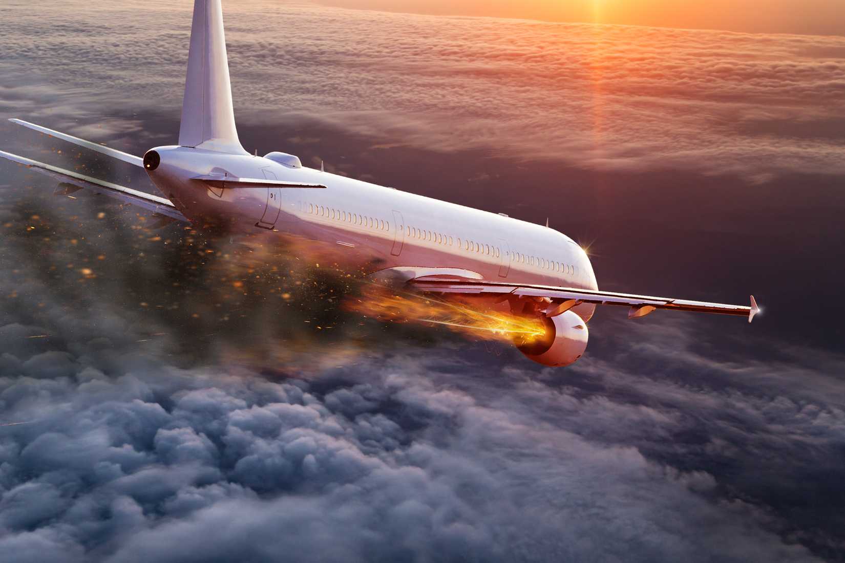 Commercial airplane with burning engine, aviation disaster concept.