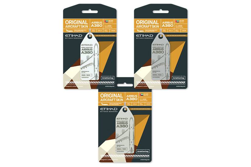 Three identical "Aviationtag" collectible packages arranged in a triangular cluster against a white background. Each dark gray and gold package features a tag made from the "original aircraft skin" of an Etihad Airbus A380, registration A6-APA. The backing card details the aircraft's service from 2014 to 2020 and its 11,000 limited run, highlighting the tag as a limited edition collectible.
