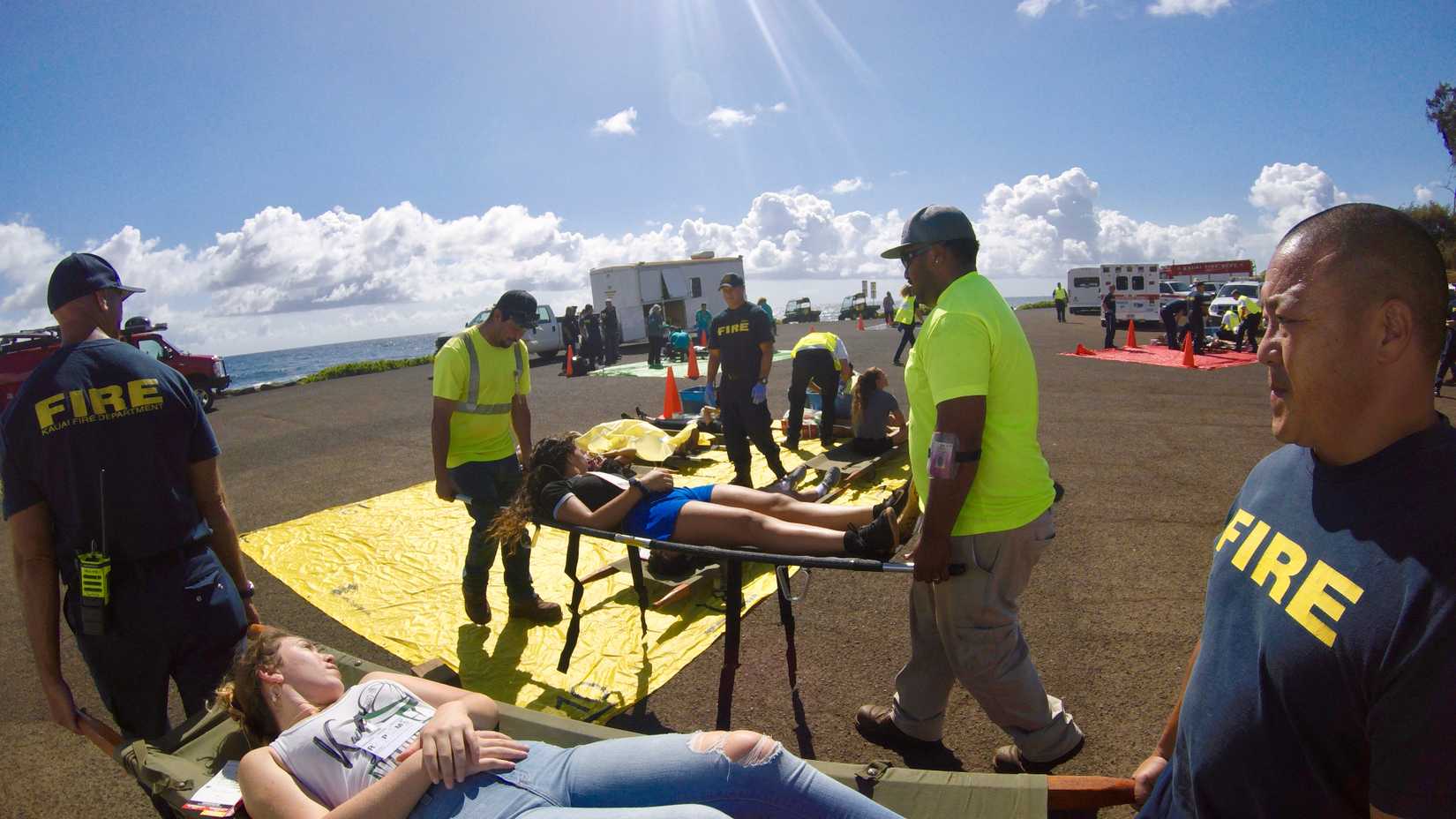 Members of Kauai County Fire Department transported Kapaa High School students simulating injured airline passengers