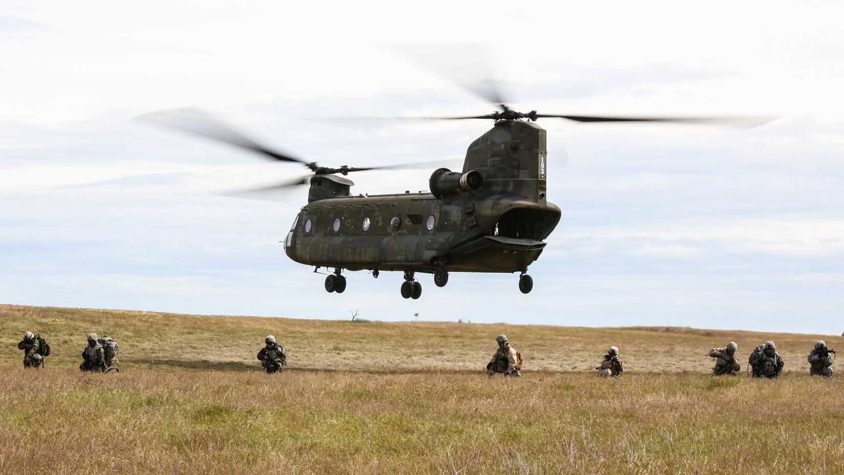 Soldiers conduct security for a departing CH-47 Chinook