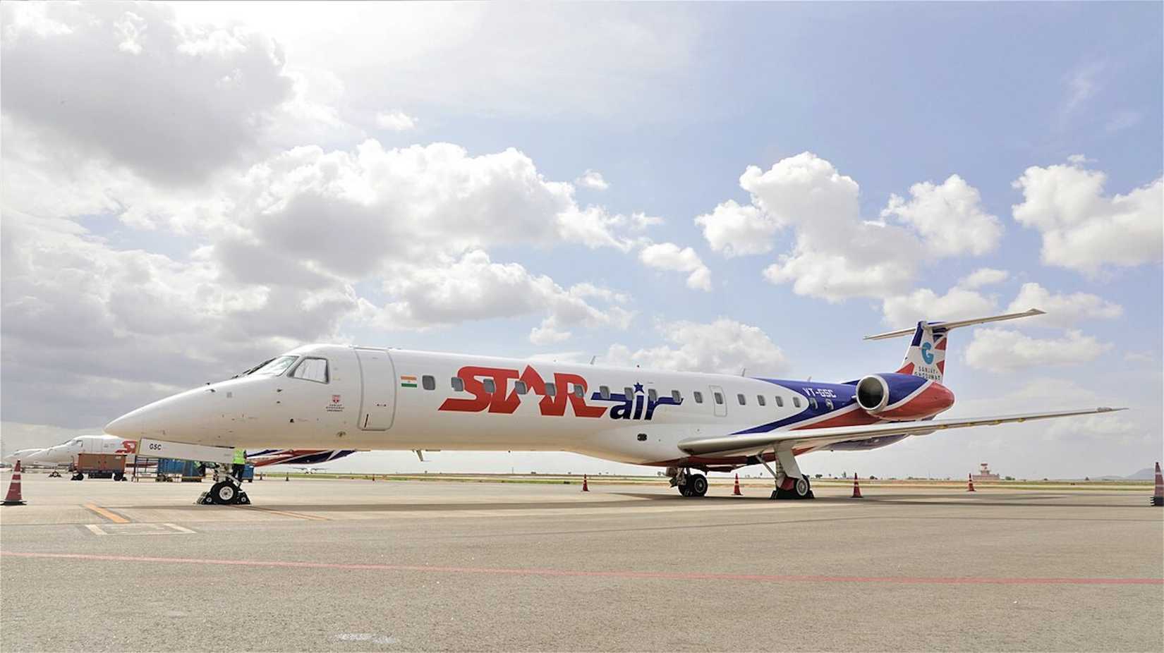 An Image Of A Star Air Aircraft Sitting On The Apron