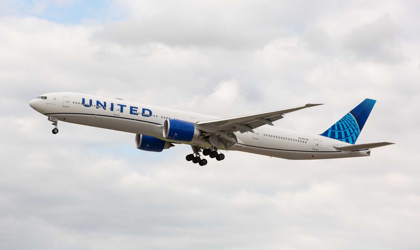 United Airlines Boeing 777-300ER displaying the new livery on final approach to O'Hare International Airport.