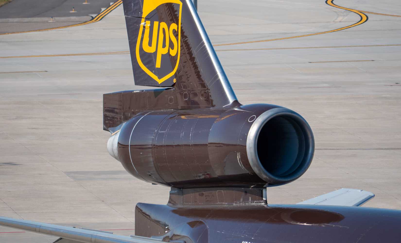 UPS MD 11 cargo plane with its close-up massive rear engine sits in Tampa Airport-1