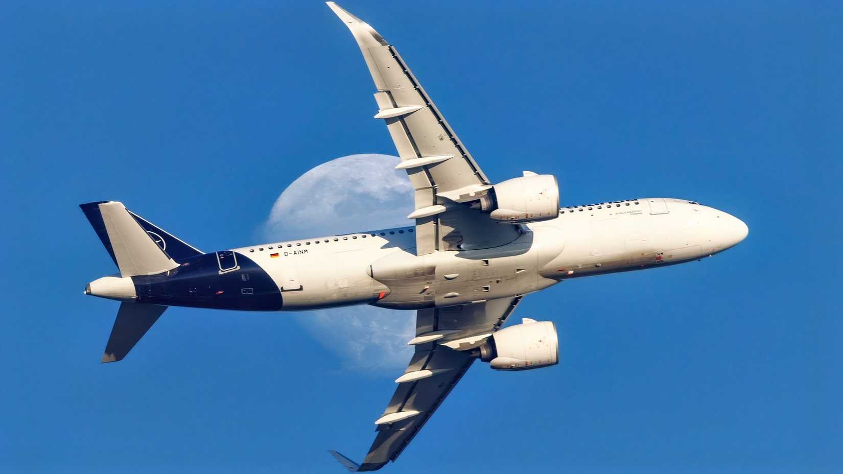 Lufthansa Airbus A320neo in the air with the moon