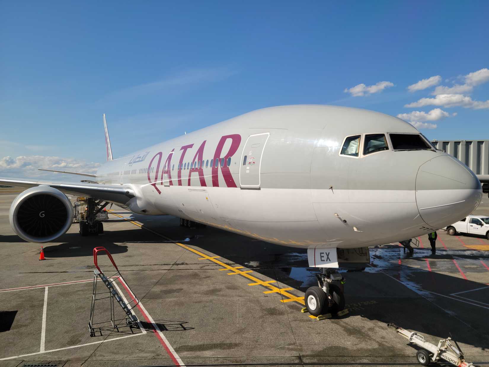 A Qatar Airways Boeing 777-300ER parked at a gate at Seattle-Tacoma International Airport.