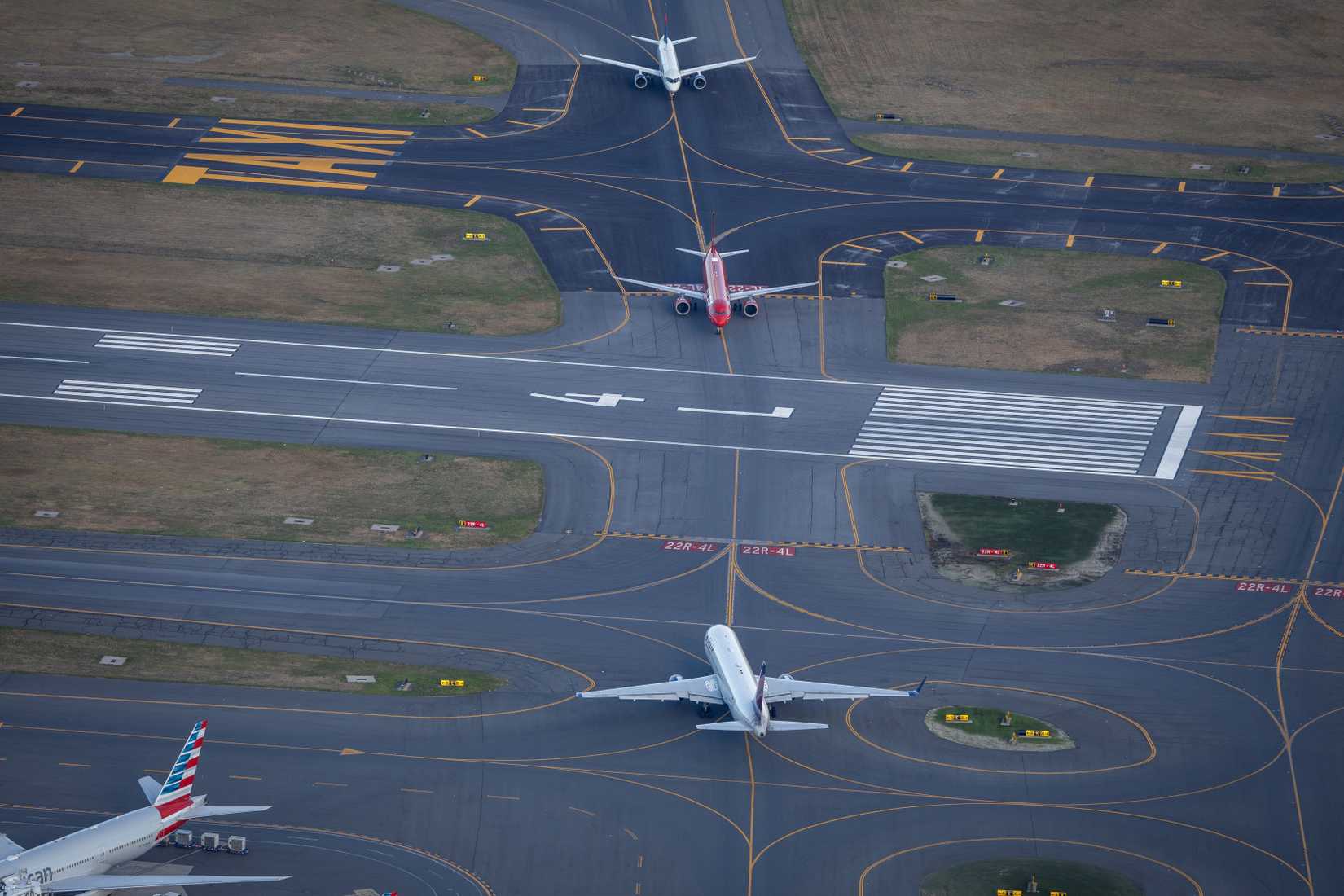 Aerial view of two planes taxiing at Boston Logan Airport.