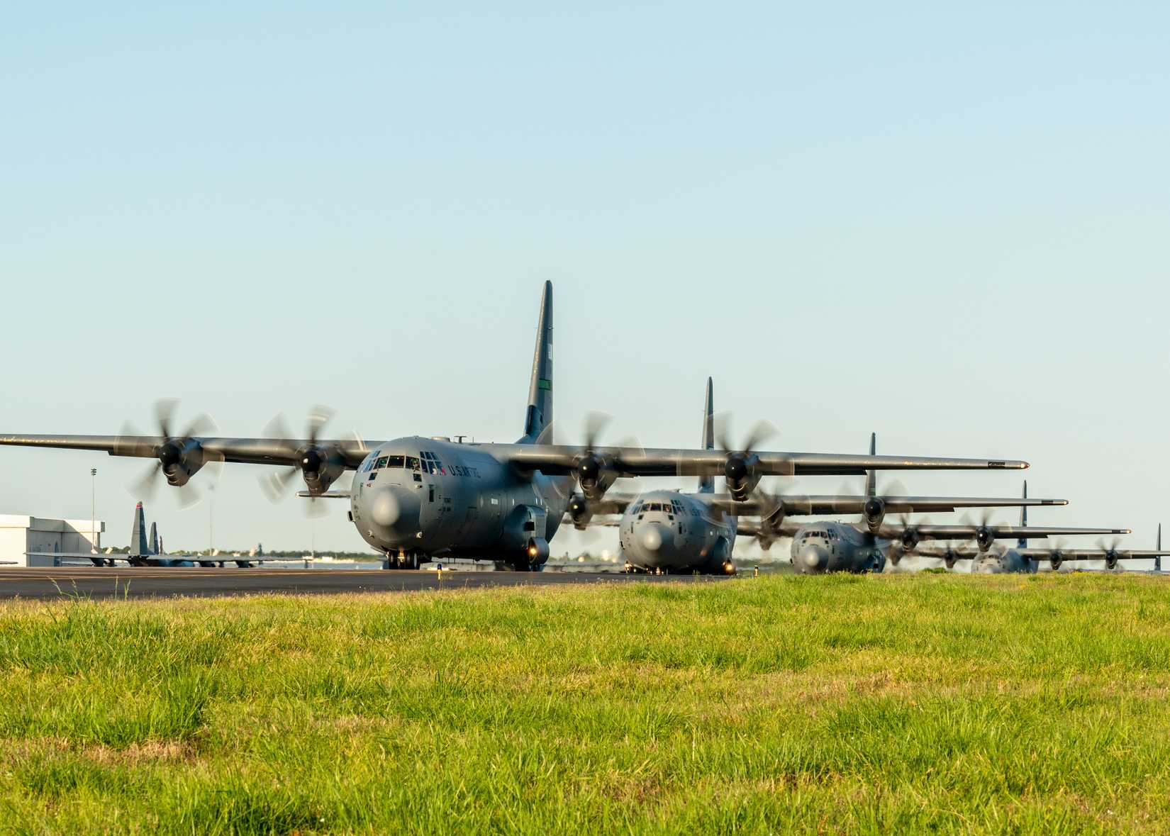 Air Force active duty and Reserve personnel take-off in a C-130J Super Hercules 12-ship formation from Little Rock Air Force Base.