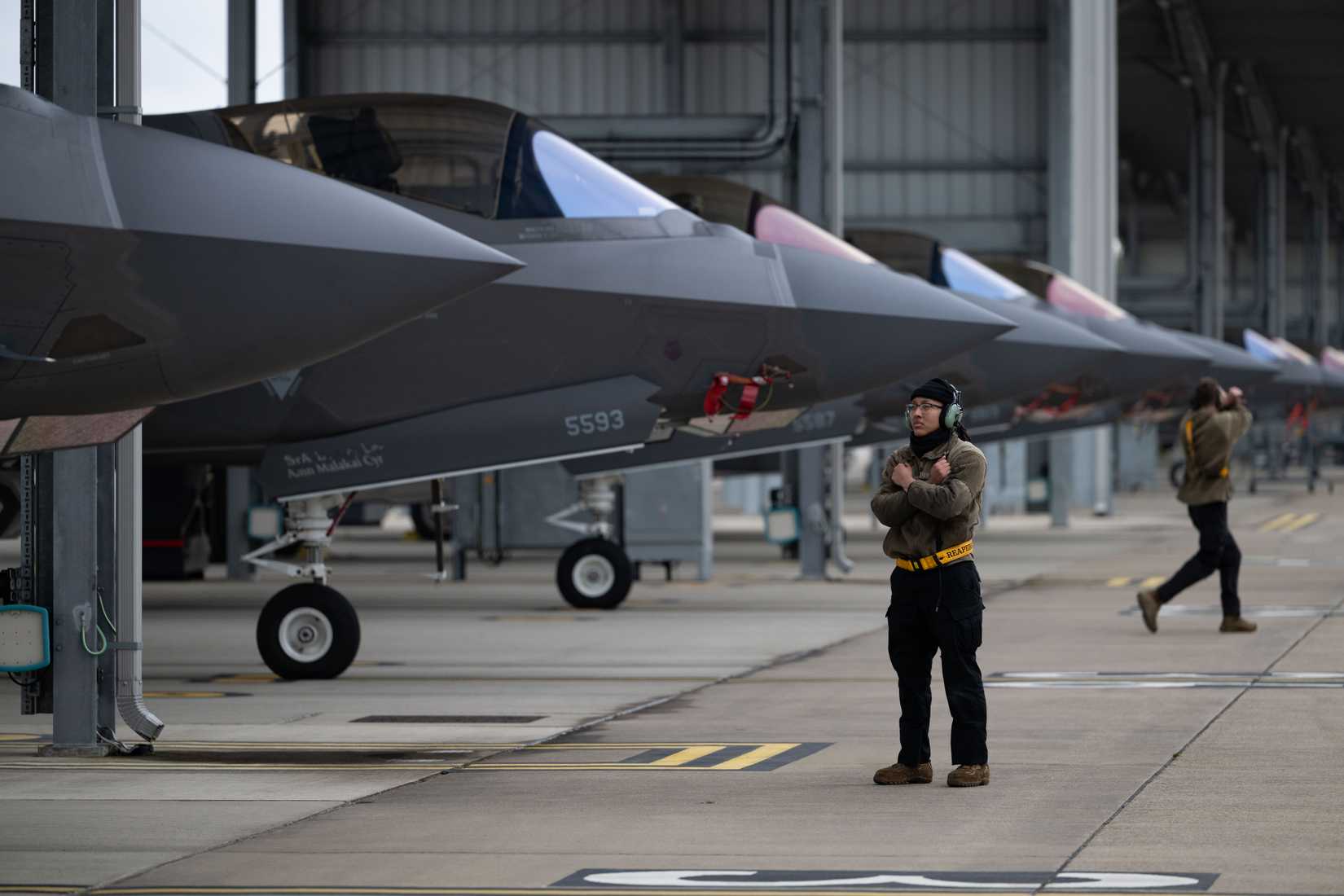 Air Force Airman 1st Class Angelina Alvarez, 493rd Fighter Generation Squadron crew chief, prepares to marshal a F-35 Lightning II
