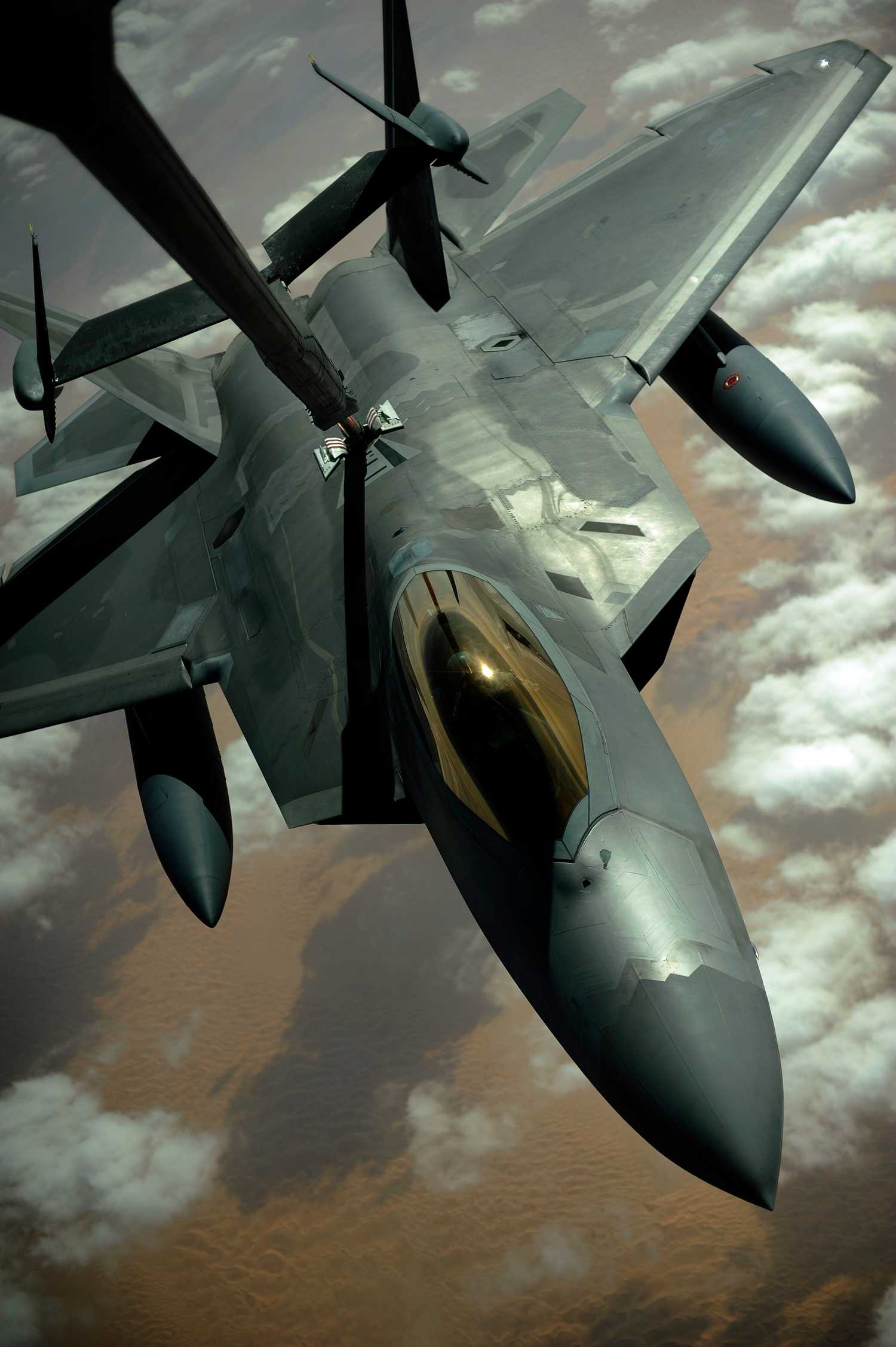 Air Force F-22 Raptor aircraft is refueled by a KC-10A Extender aircraft with the 908th Expeditionary Air Refueling Squadron