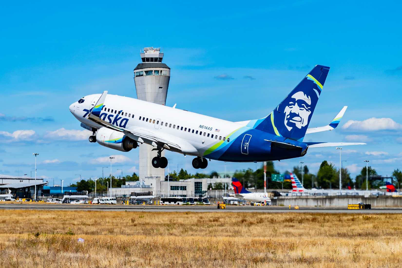 Alaska Airlines 737-700 Taking Off at SEA Past Delta Air Lines and American Airlines Tailsta
