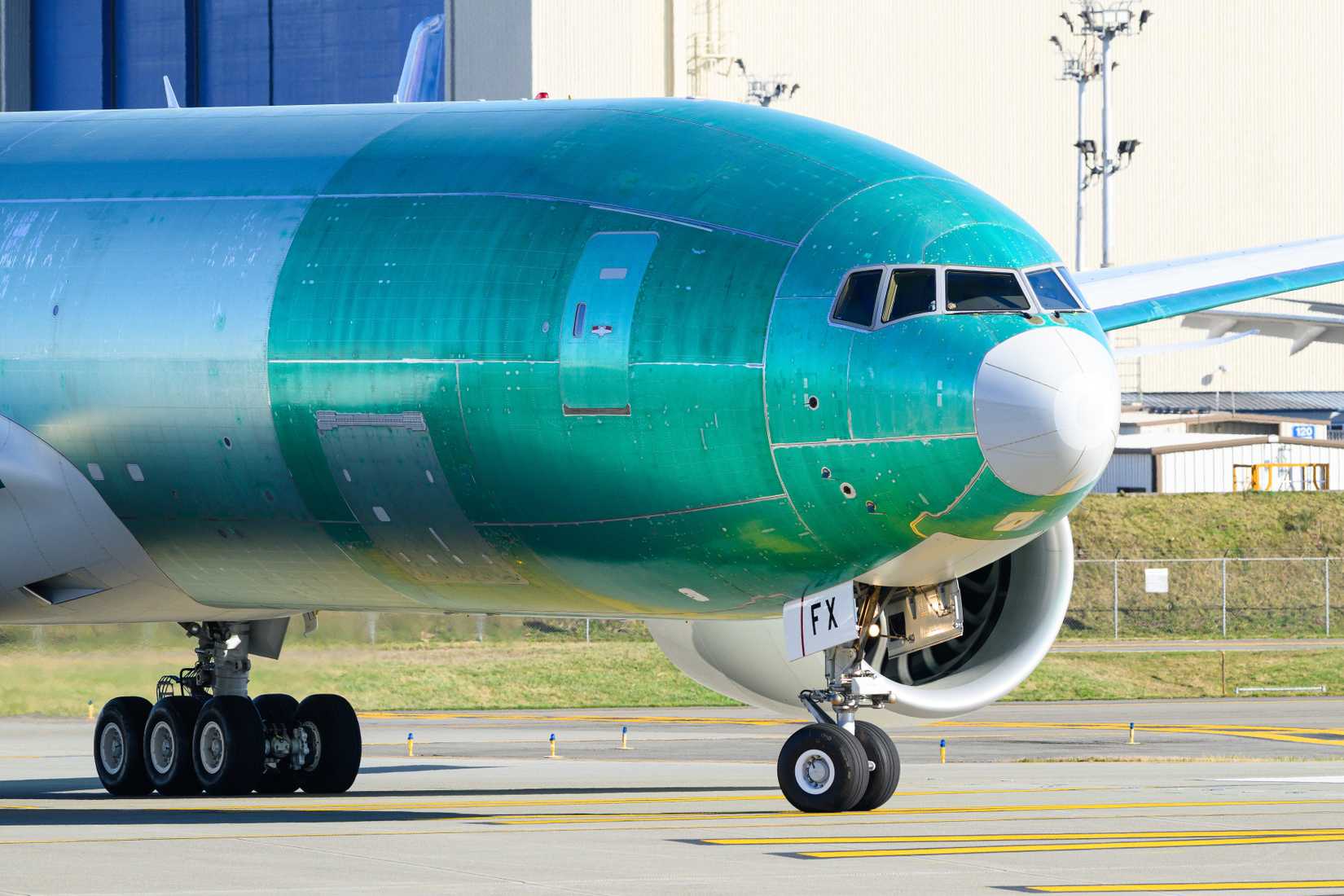 Boeing 777-F cargo freighter taxiing for first flight in protective green.