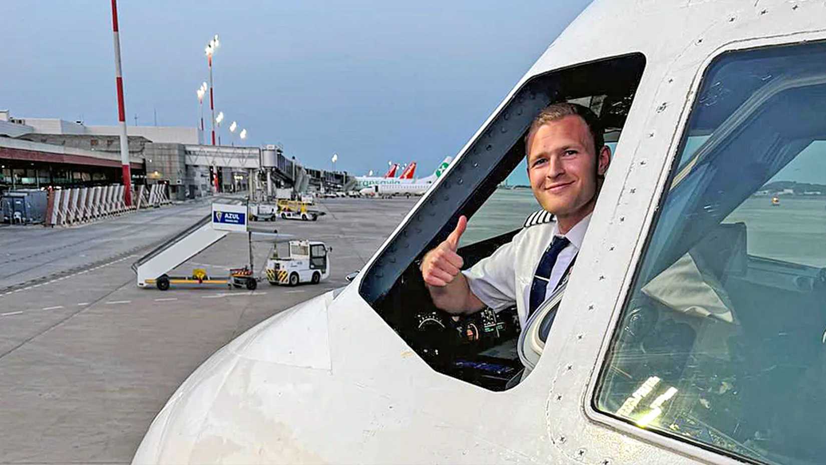 A British Airways pilot gives the thumbs up signal from the cockpit