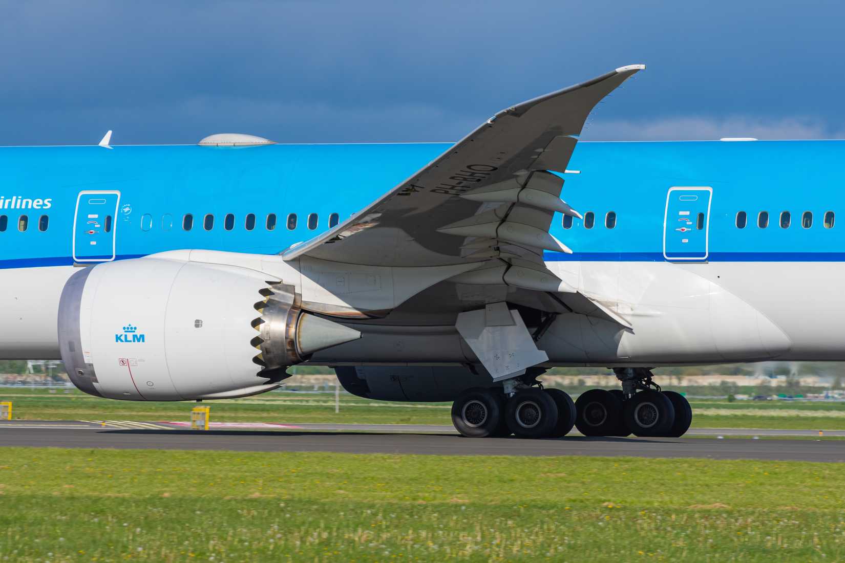 Close up to main landing gear and General Electric GEnx engine of KLM Royal Dutch Airlines Boeing 787-10 Dreamliner