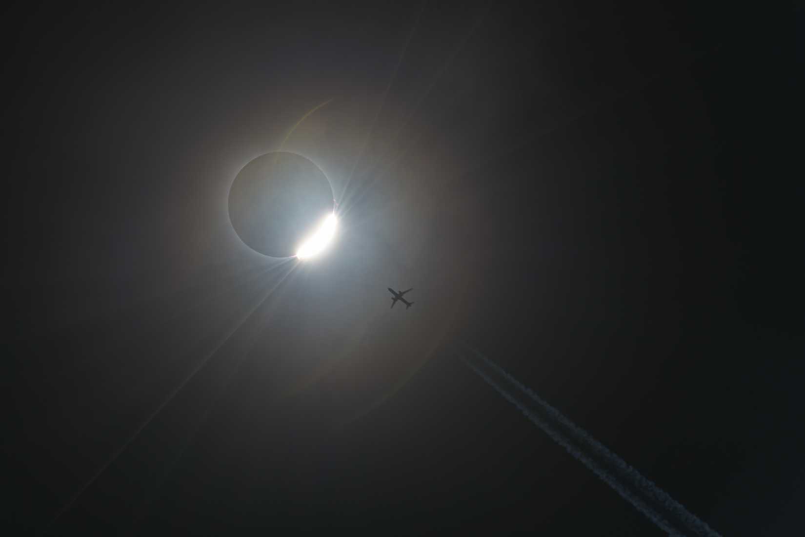 A full solar eclipse and an aircraft flying close to it