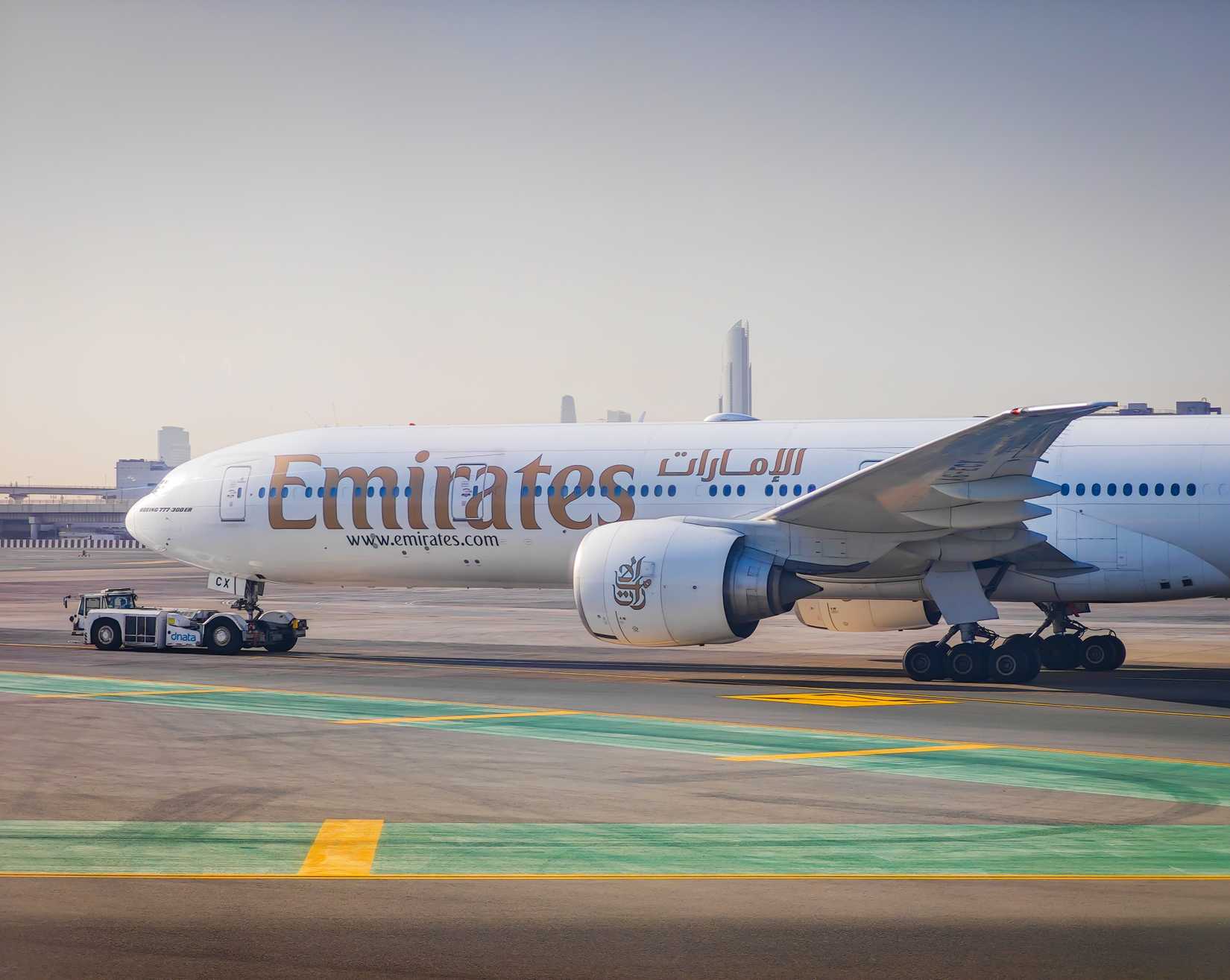 Emirates airlines aircraft taxiing at Dubai International Airport.