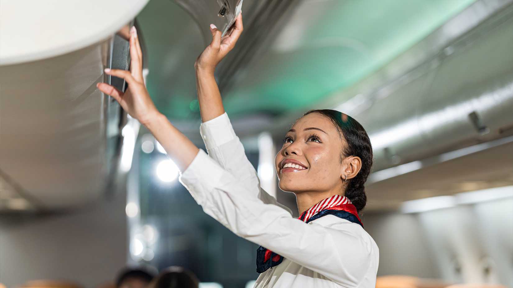 Flight Attendant Closing Overhead Locker