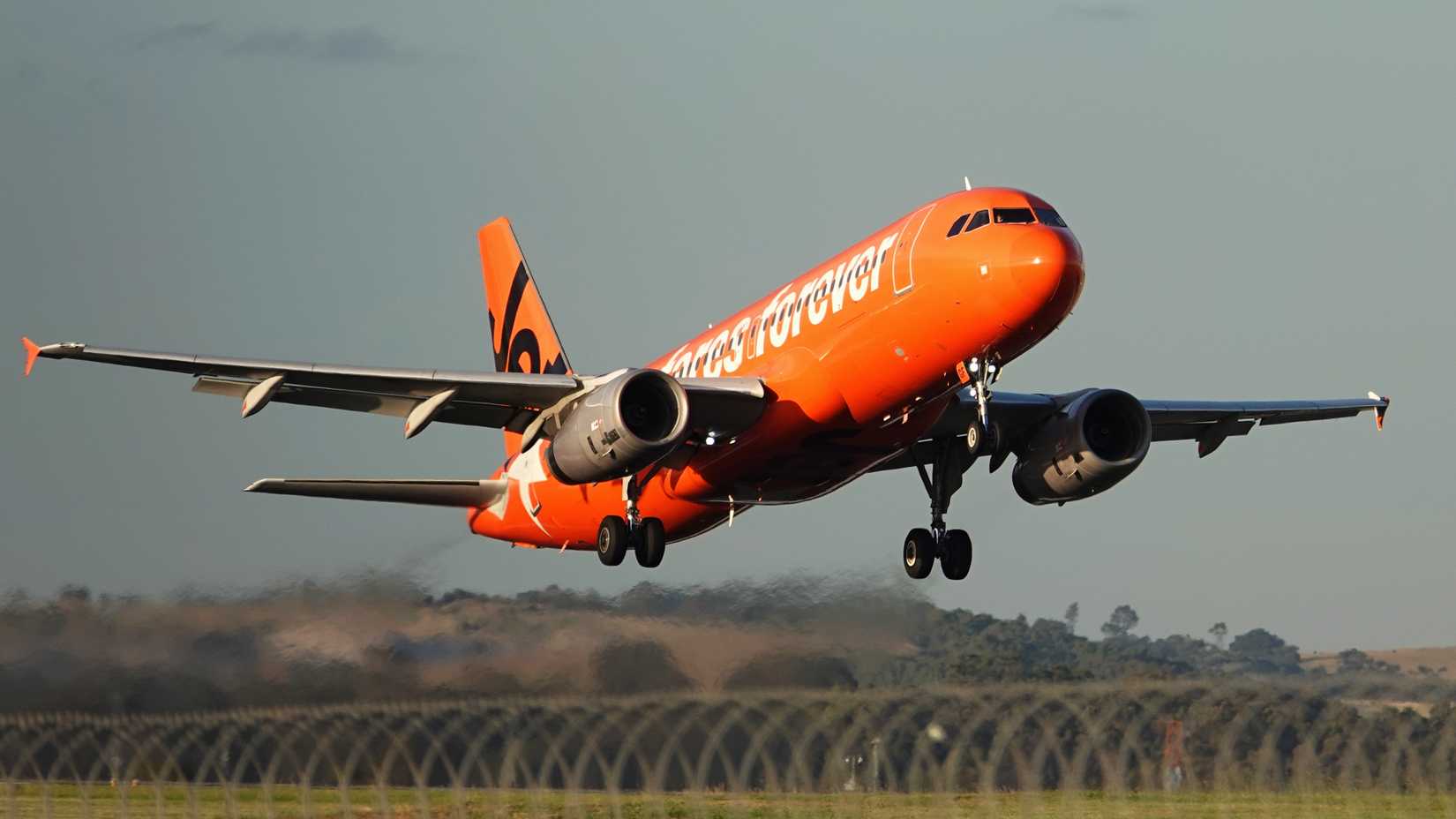 Jetstar Australian Airlines plane takes off from Melbourne Airport in blue sky