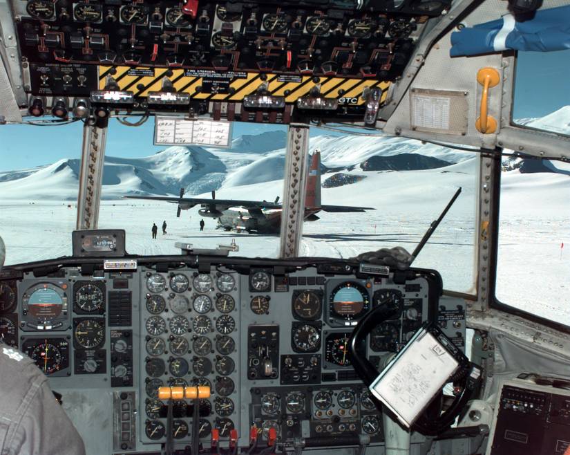 Navy LC-130 Hercules ski-equipped cargo plane is visible from the cockpit of another Hercules