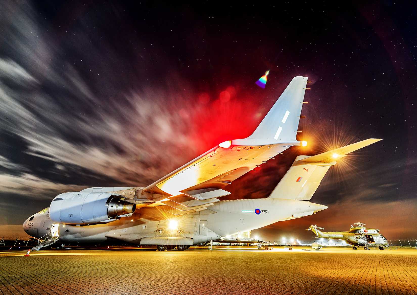 A Royal Air Force Puma Mark2 being loaded onto a Royal Air Force C-17A Globemaster of No. 99 Squadron at RAF Brize Norton