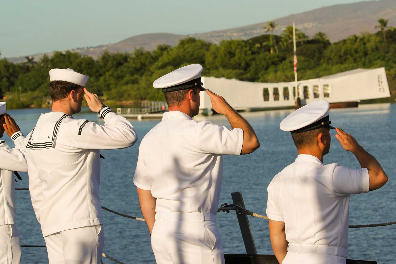 Sailors aboard the USS Carl M. Levin salute the Arizona Memorial during the 84th Anniversary Pearl Harbor Day commemoration