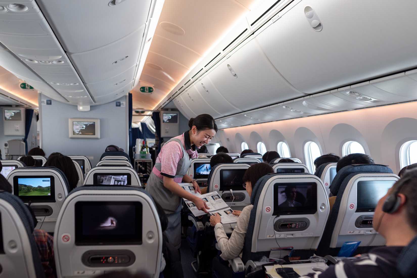 Japan ANA Airlines and Boeing 787 Dreamliner interior with People And ANA Cabin Crew Members working for passangers.