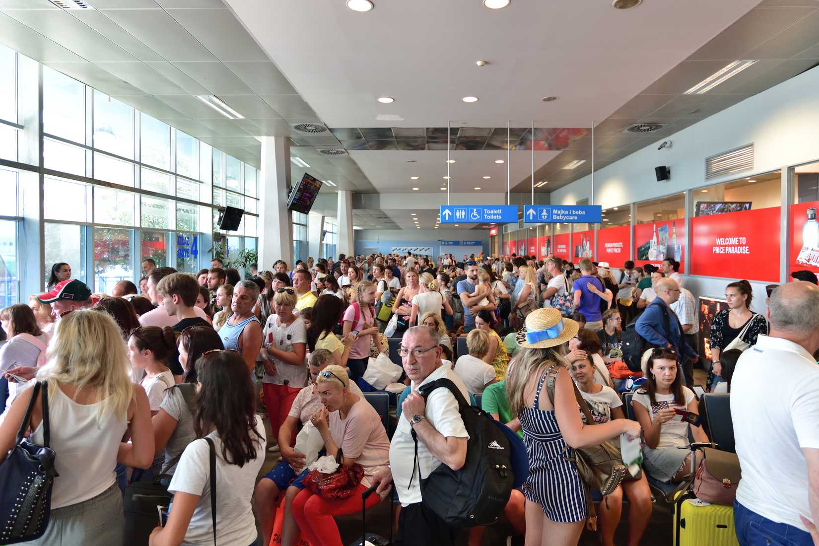 Crowded Departure hall of international airport Tivat