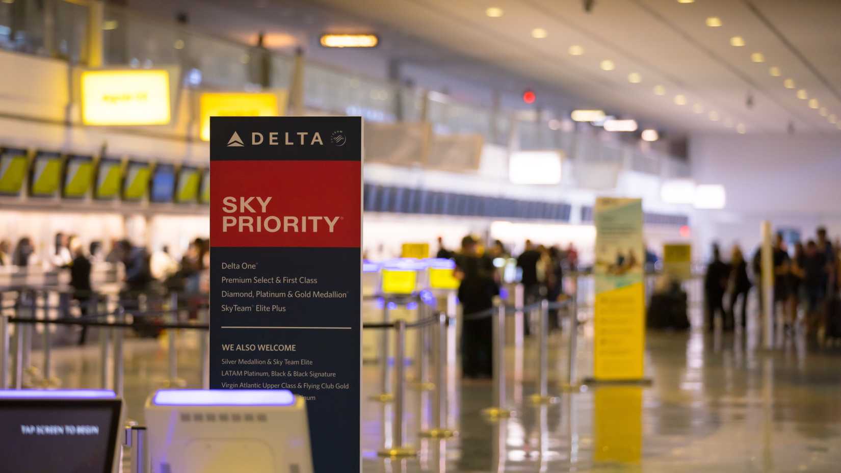 Sign of Delta Sky Priority check-in lane for passengers with Medallion status and on premium cabins. Harry Reid International Airport. Terminal in bokeh in background.