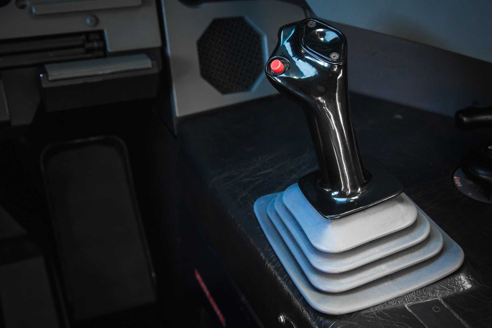 One of the sidesticks in an A320 cockpit with copy space on the left. Right hand side, first officer side.