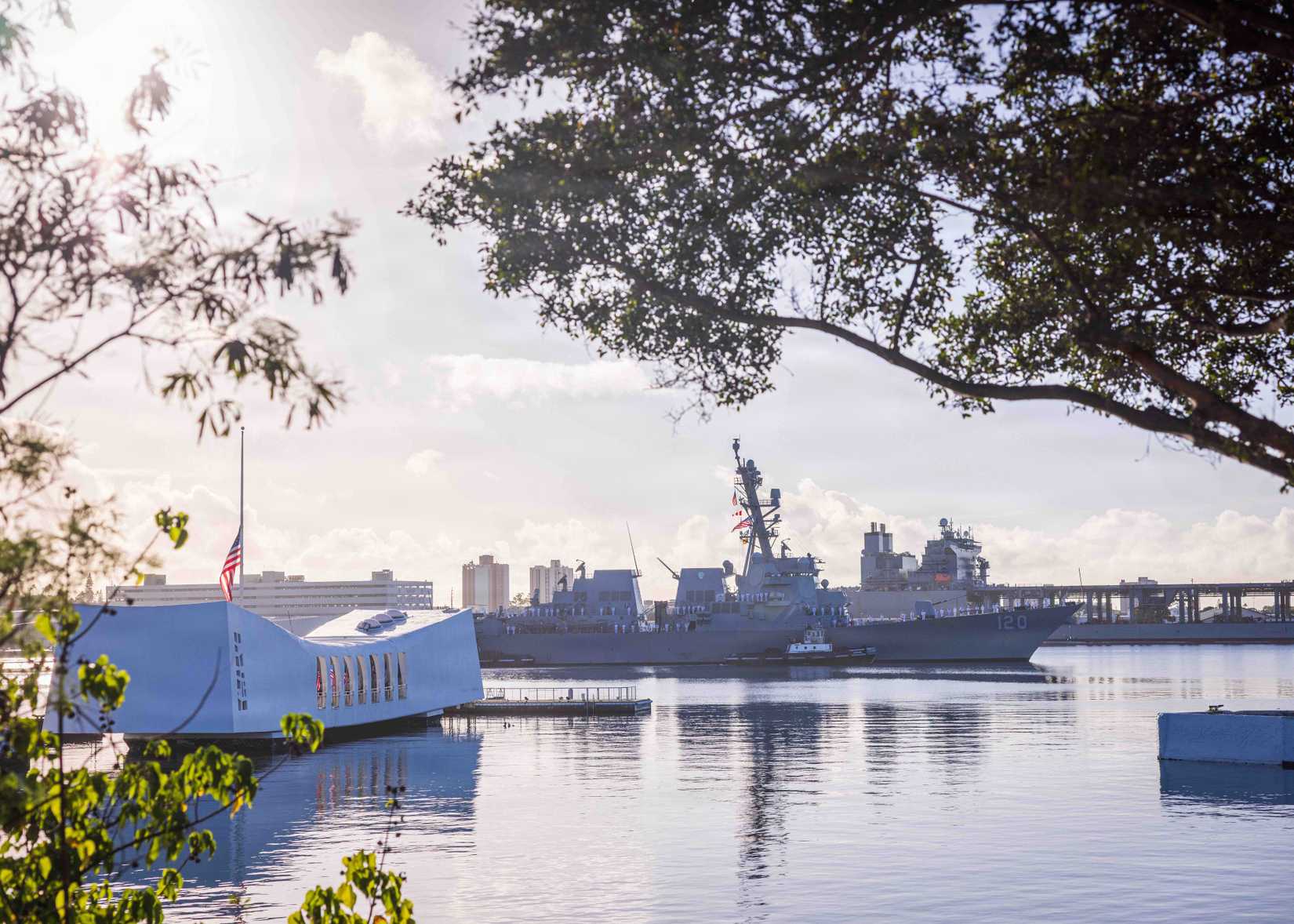 The Arleigh Burke-class guided-missile destroyer USS Carl M. Levin (DDG 120) conducts a pass-in-review during the 84th National Pearl Harbor Remembrance Day.