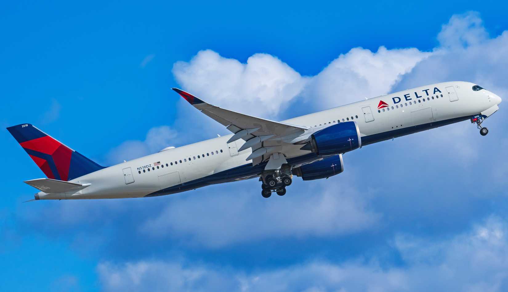 A Delta Air Lines Airbus A350-900 long-range widebody airliner departs from Tampa International Airport (TPA) with stormy skies.