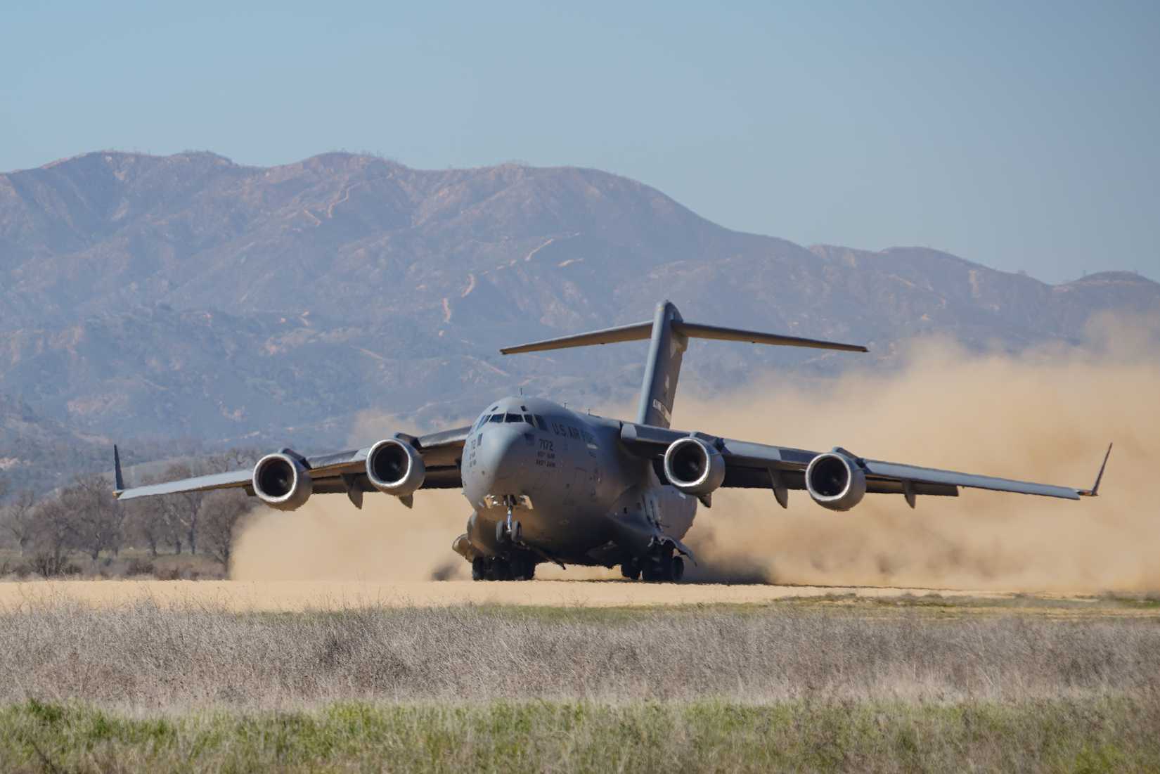 Air Force C-17 assigned to 21st Airlift Squadron departs on an improvised dirt runway at Fort Hunter Liggett, California, February 8, 2022.