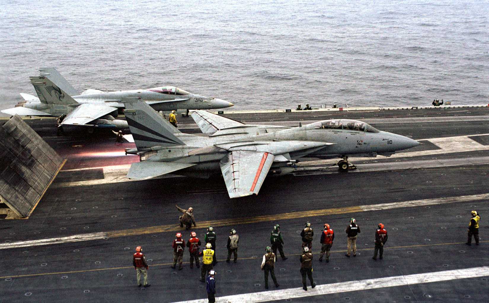 An F-14 Tomcat hits the afterburner before launching from the aircraft carrier USS Kitty Hawk (CV 63) during Exercise Foal Eagle '99 on Oct. 31, 1999.