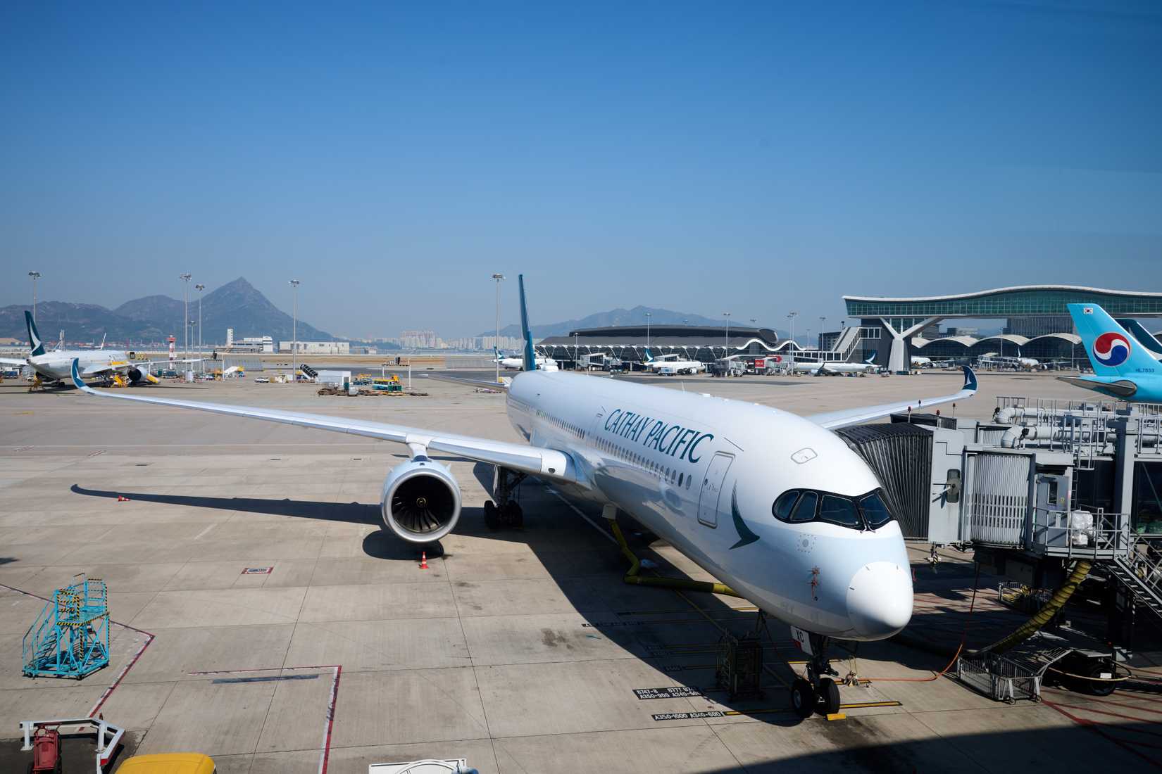 Cathay Pacific A350 at HKG gate with jet bridge.