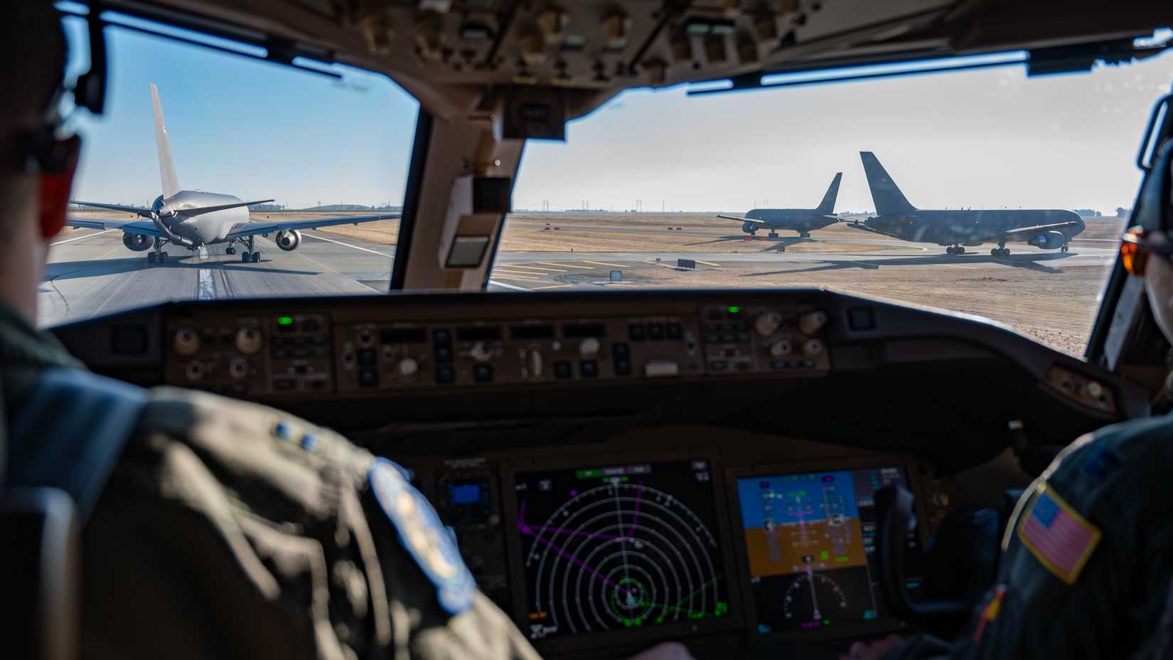 Four US Air Force KC-46A Pegasus aircraft assigned to the 6th and 9th Air Refueling Squadrons taxi during a training flight at Travis Air Force Base.