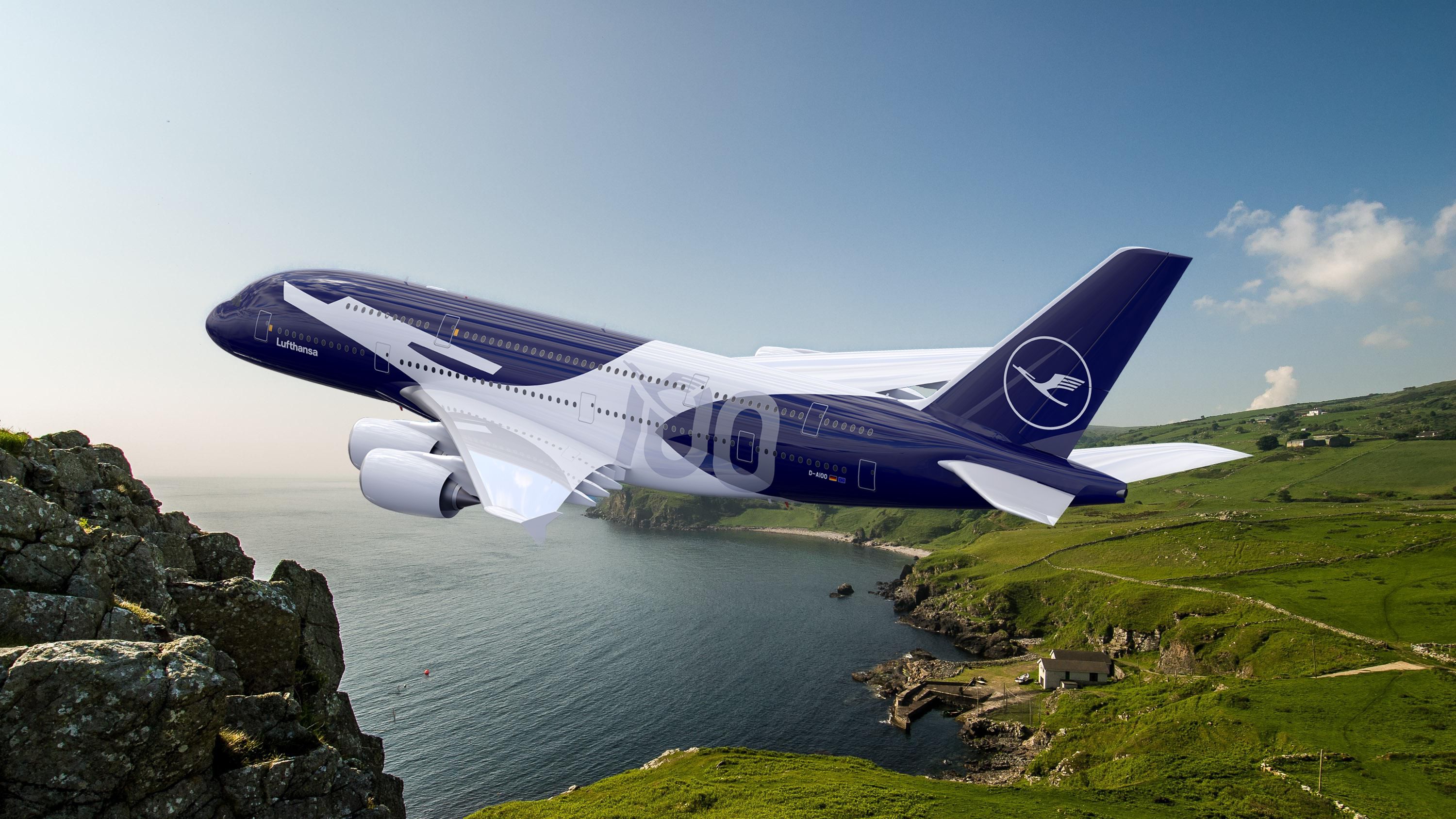   A side view of a Lufthansa Airbus A380 banking sharply over a rugged, green coastal landscape. The aircraft features a special 