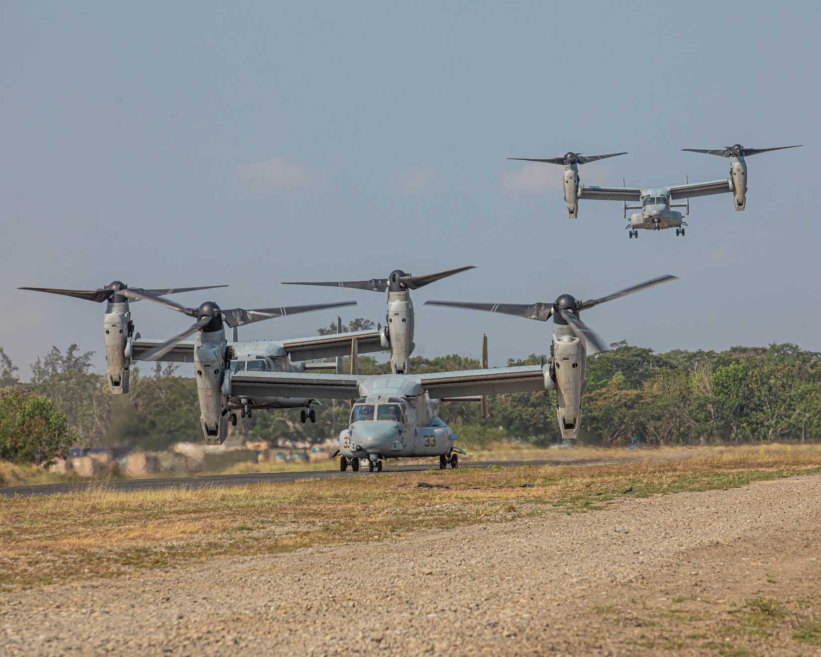 Marine Corps V-22 Ospreys land to transport U.S. Army, Australian Defense Force, and Philippine Army Soldiers for air assault