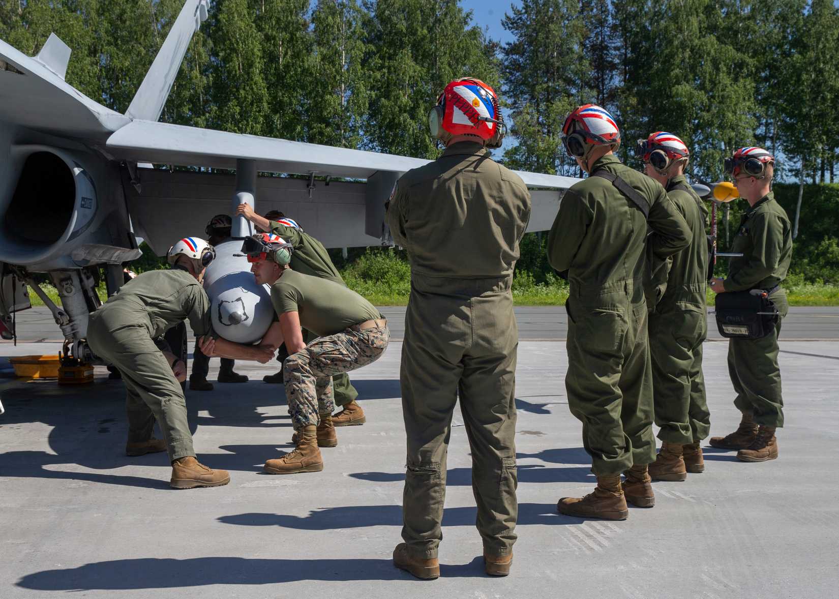 U.S. Marines with Marine Fighter Attack Squadron (VMFA) 115 remove the left external fuel tank on a F/A-18C Hornet after a flight at Rissala Air Base, near Kuopio, Finland, June 8, 2021.