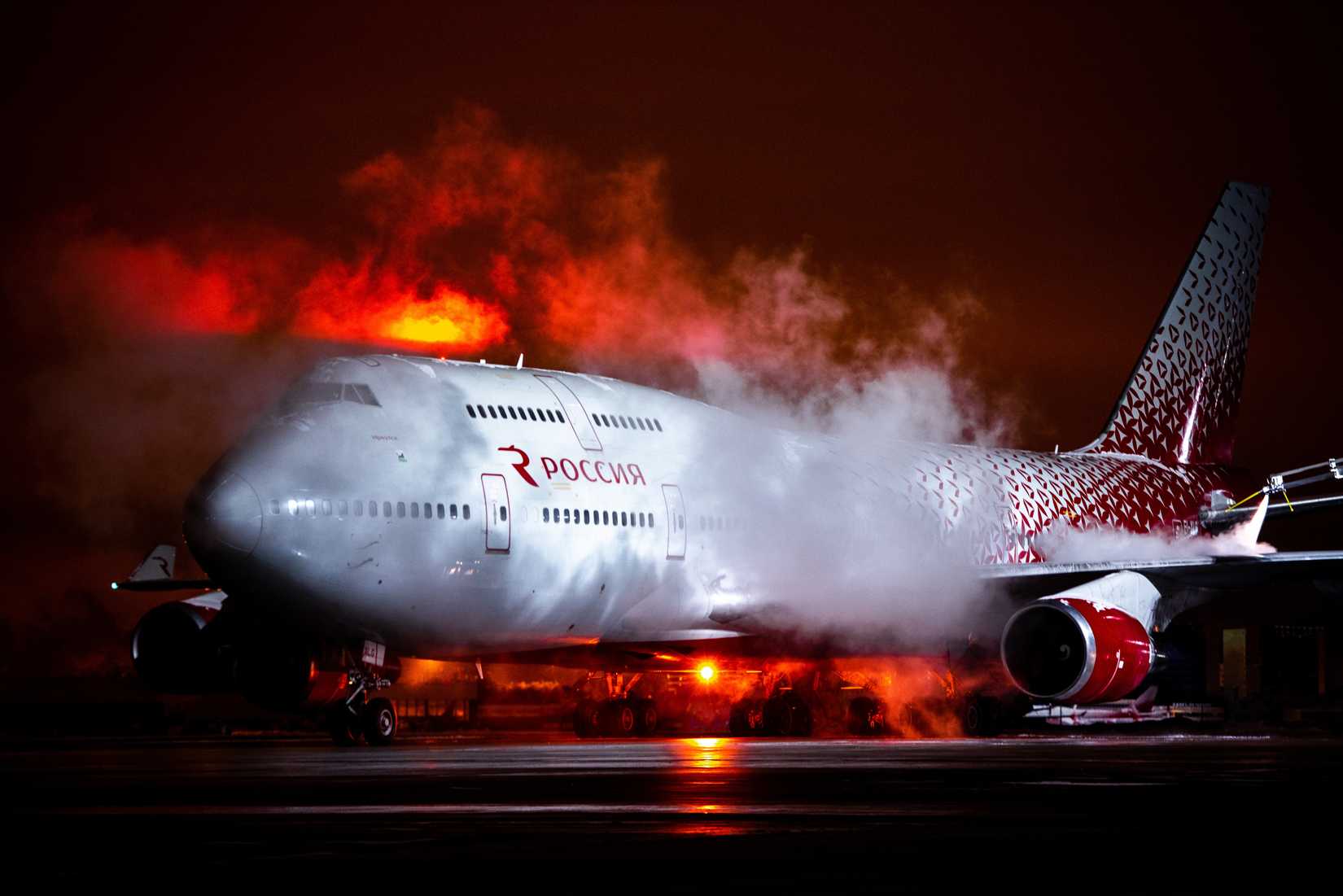 Rossiya Airlines Boeing 747-400 on the stand during de-icing procedures.