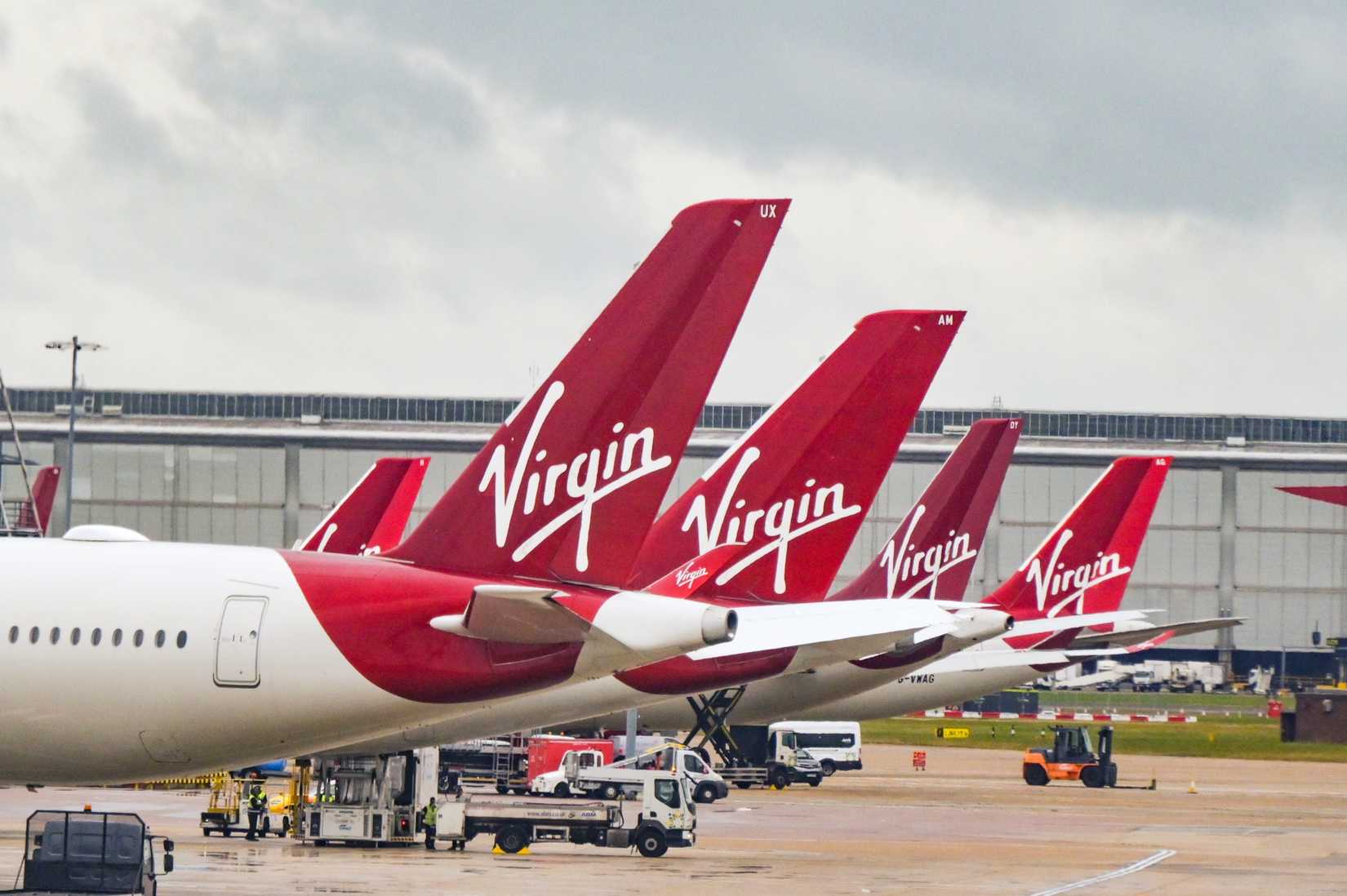 Row of tail fins of passenger planes operated by Virgin Atlantic Airways at London Heathrow airport.