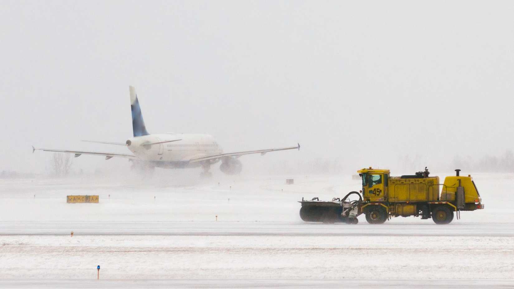 Snow ploughs attempt to clear the snow at Buffalo Niagara International Airport