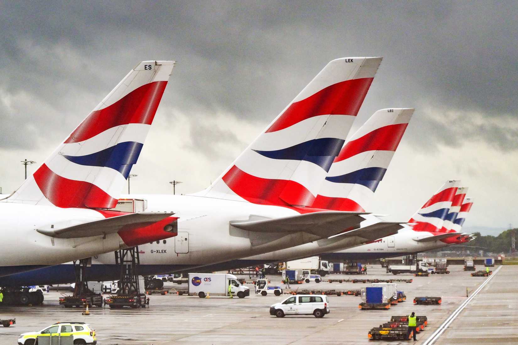 Tail fins of British Airways jets at London Heathrow airport.