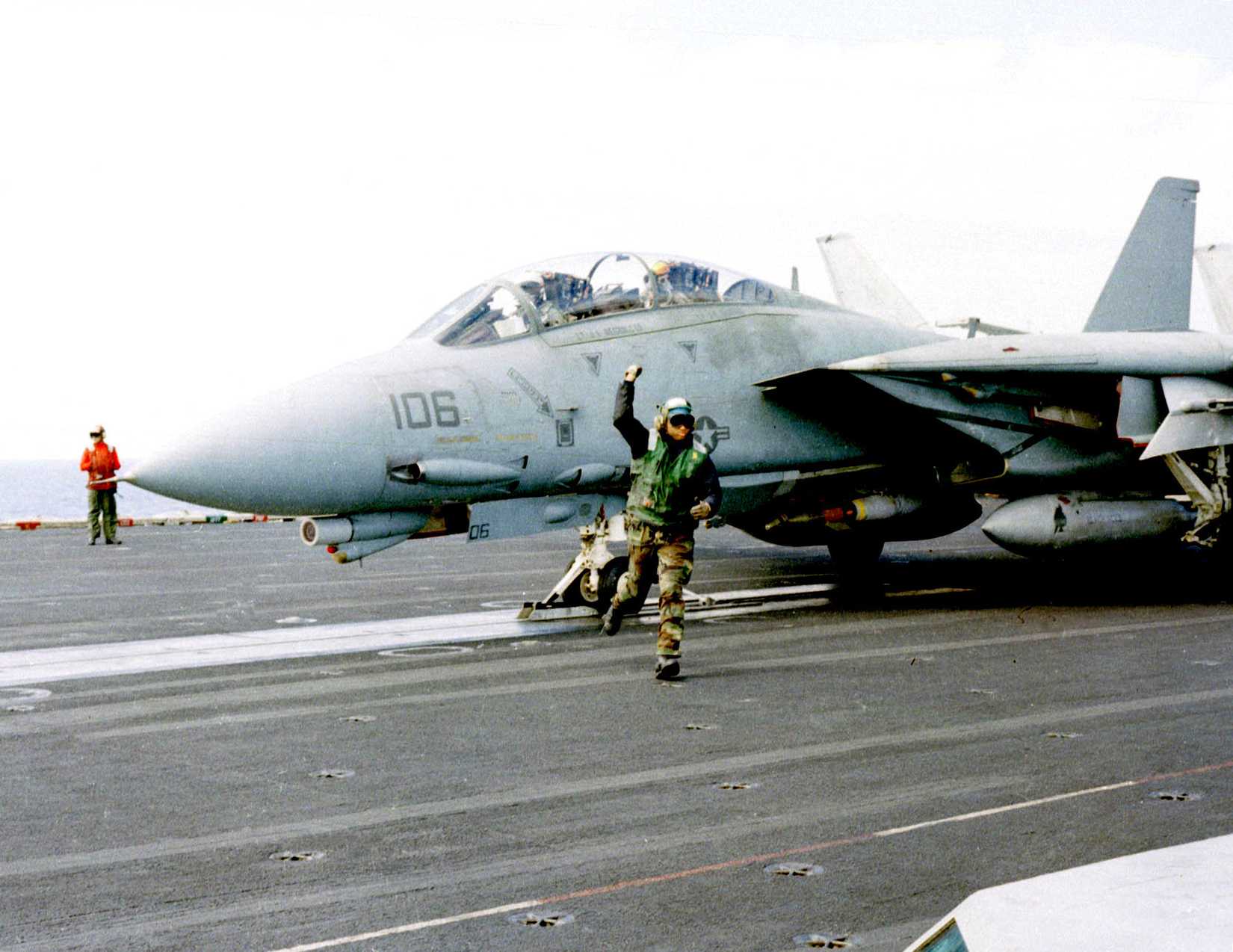 Thumbs up signal indicating the F-14 Tomcat fighter is ready for launch from USS Theodore Roosevelt (CVN 71) for NATO Operation Allied Force, 1999.