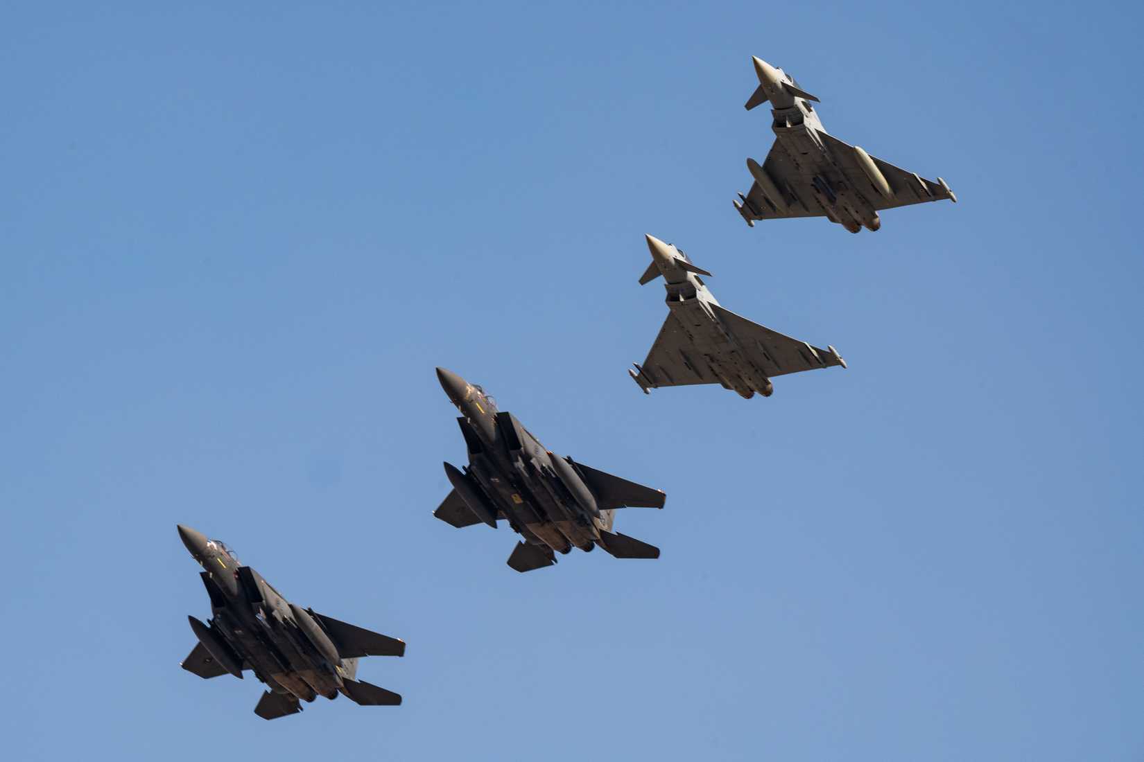 U.S. Air Force F-15E Strike Eagles and two Kuwaiti Eurofighter Typhoons fly a four-ship formation during exercise Marauder Shield 2026.