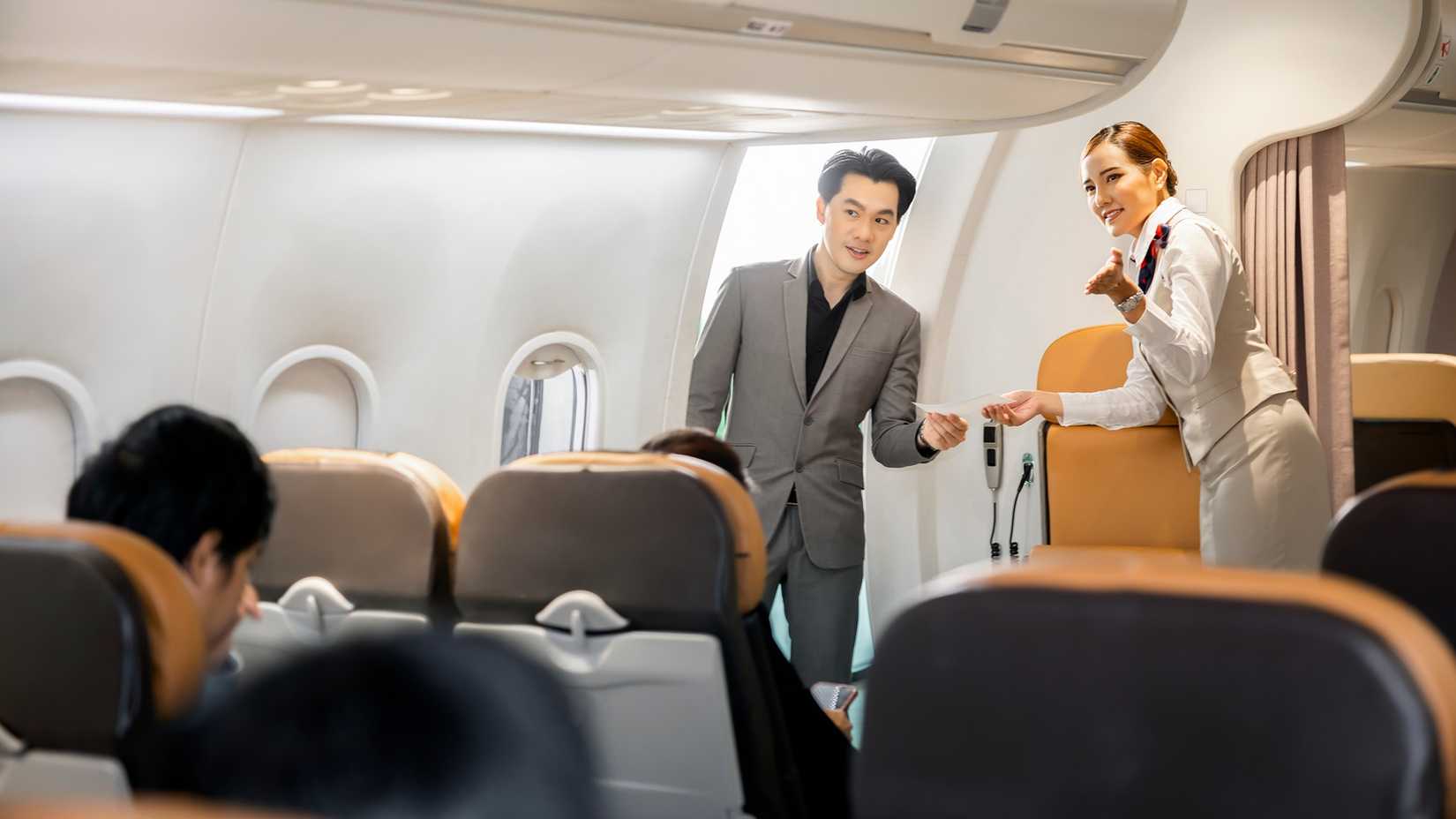 Welcome onboard flight attendant greeting passenger (1)