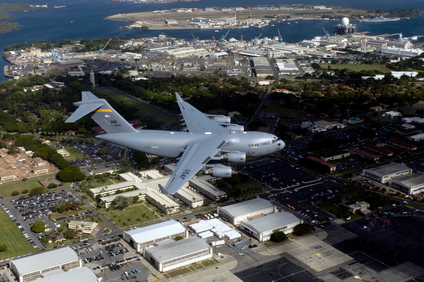 The first Hawaii-based C-17 Globemaster III flies over Hickam Air Force Base and nearby Pearl Harbor for the arrival ceremony, 2006.