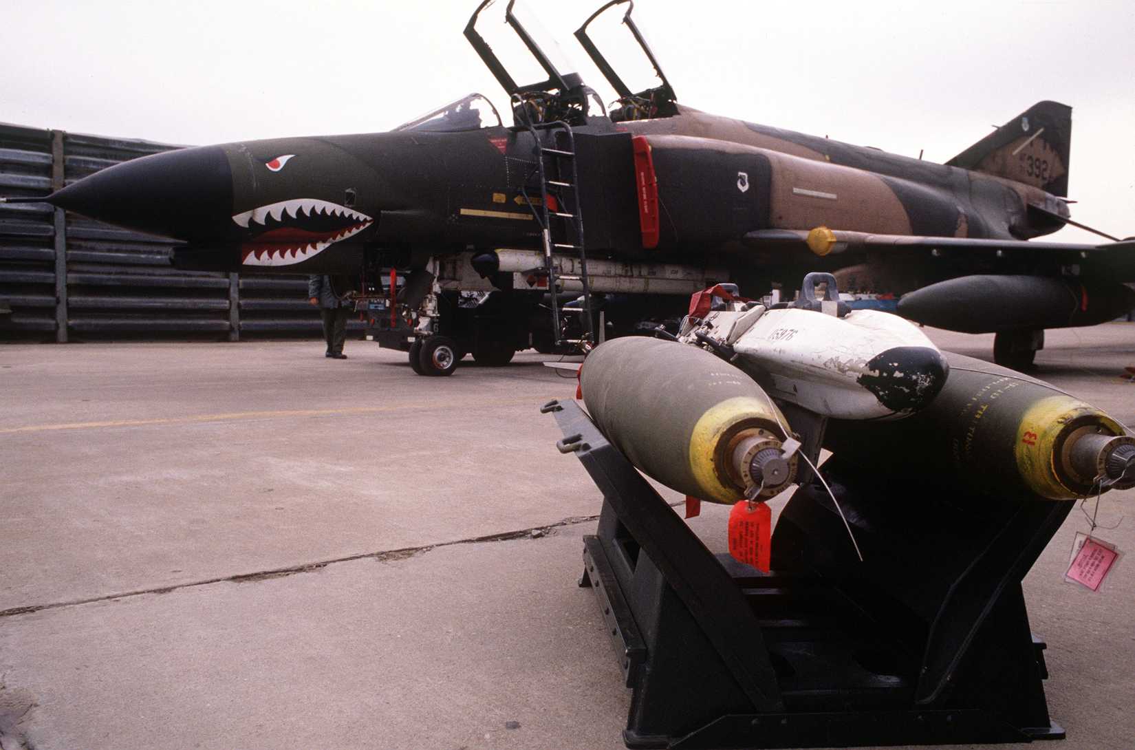A bomb rack with two Mark 82 bombs is ready to be loaded on an F-4 Phantom II
