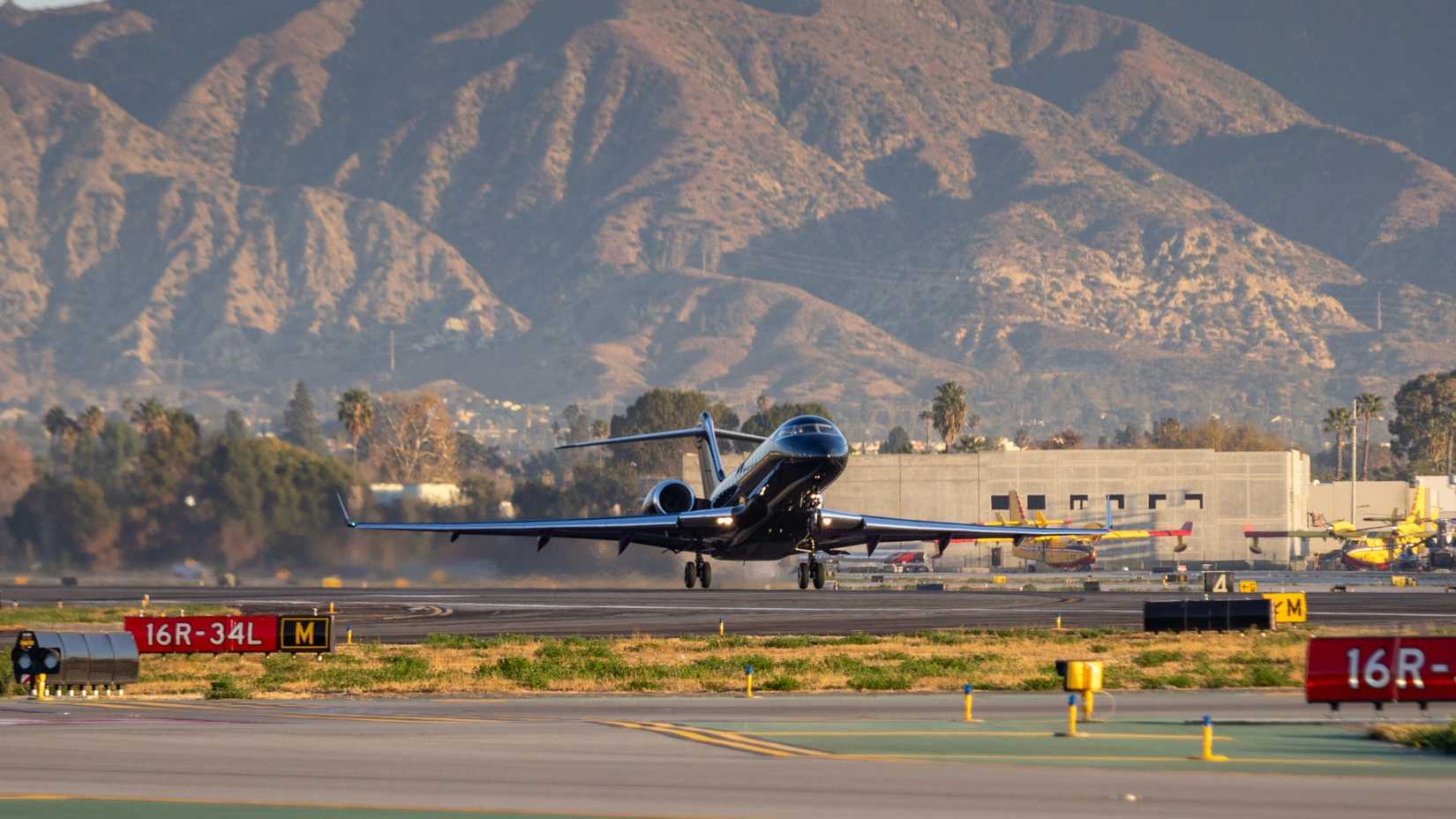 A Bombardier Global Express on a early morning departure from runway 16R at KVNY.