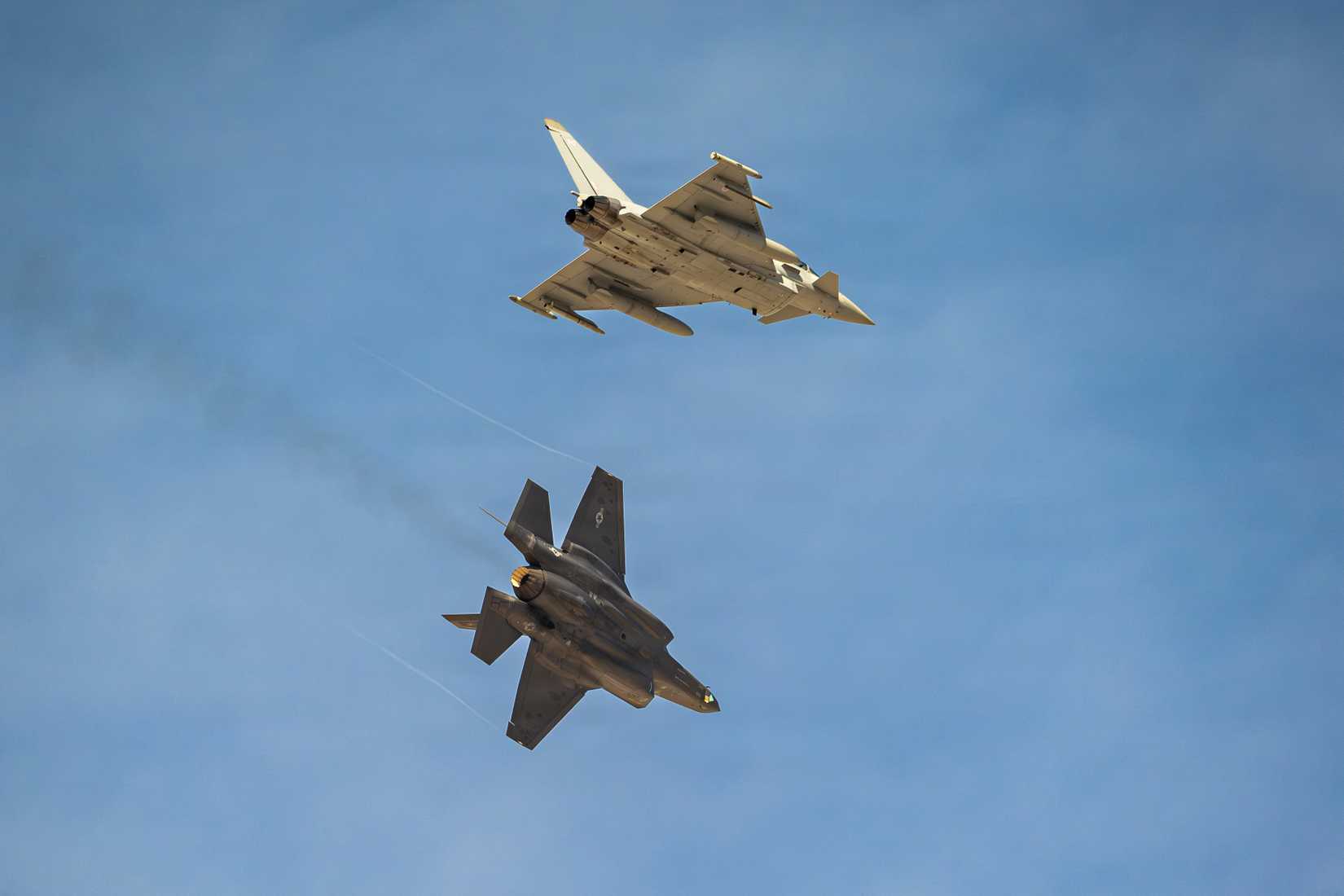 A British Royal Air Force Eurofighter Typhoon and a U.S. Air Force F-35A Lightning II prepare to land at Nellis Air Force Base.
